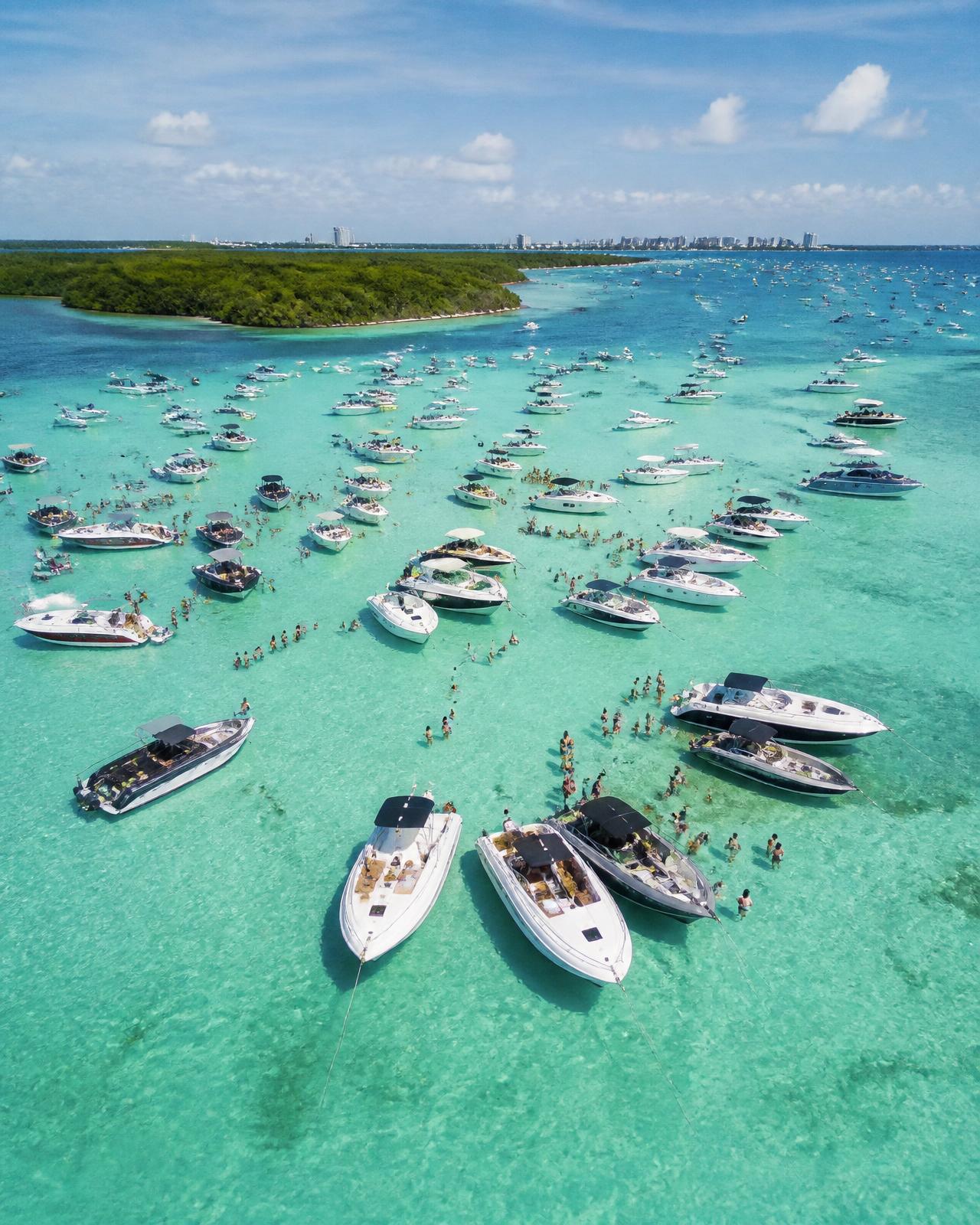 Boats anchored on the turquoise water of Haulover Sandbar in Miami